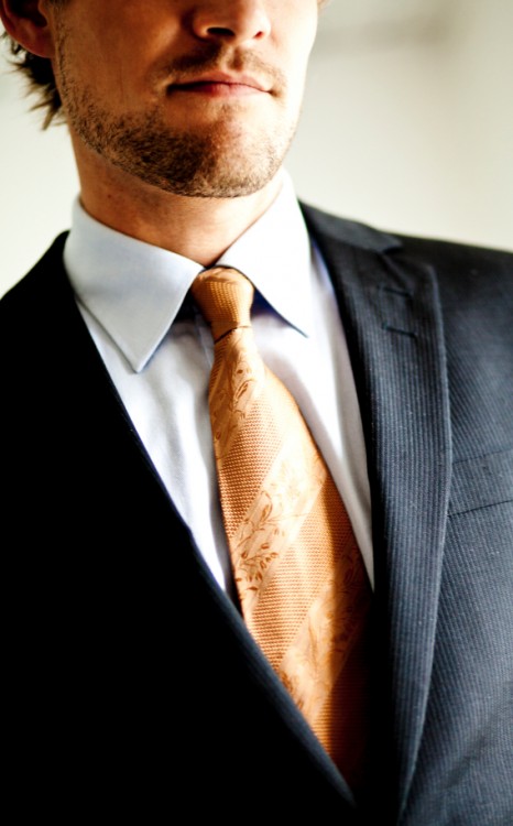 Man wearing a suit and tie (WIndsor knot?)